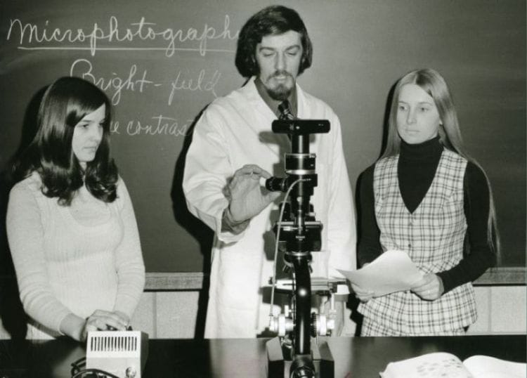 Professor Gern Jaeger demonstrating microphotographic equipment in the Biology lab, 1973