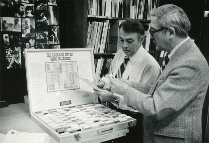 SUNY Niagara History Professors, Clyde Tyson and Graham Millar, reviewing slides for an upcoming program, 1984