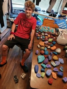 Robert Garris shows collection of “kindness stones” created for the SUNY Niagara Liberty Kindness Rock Garden.